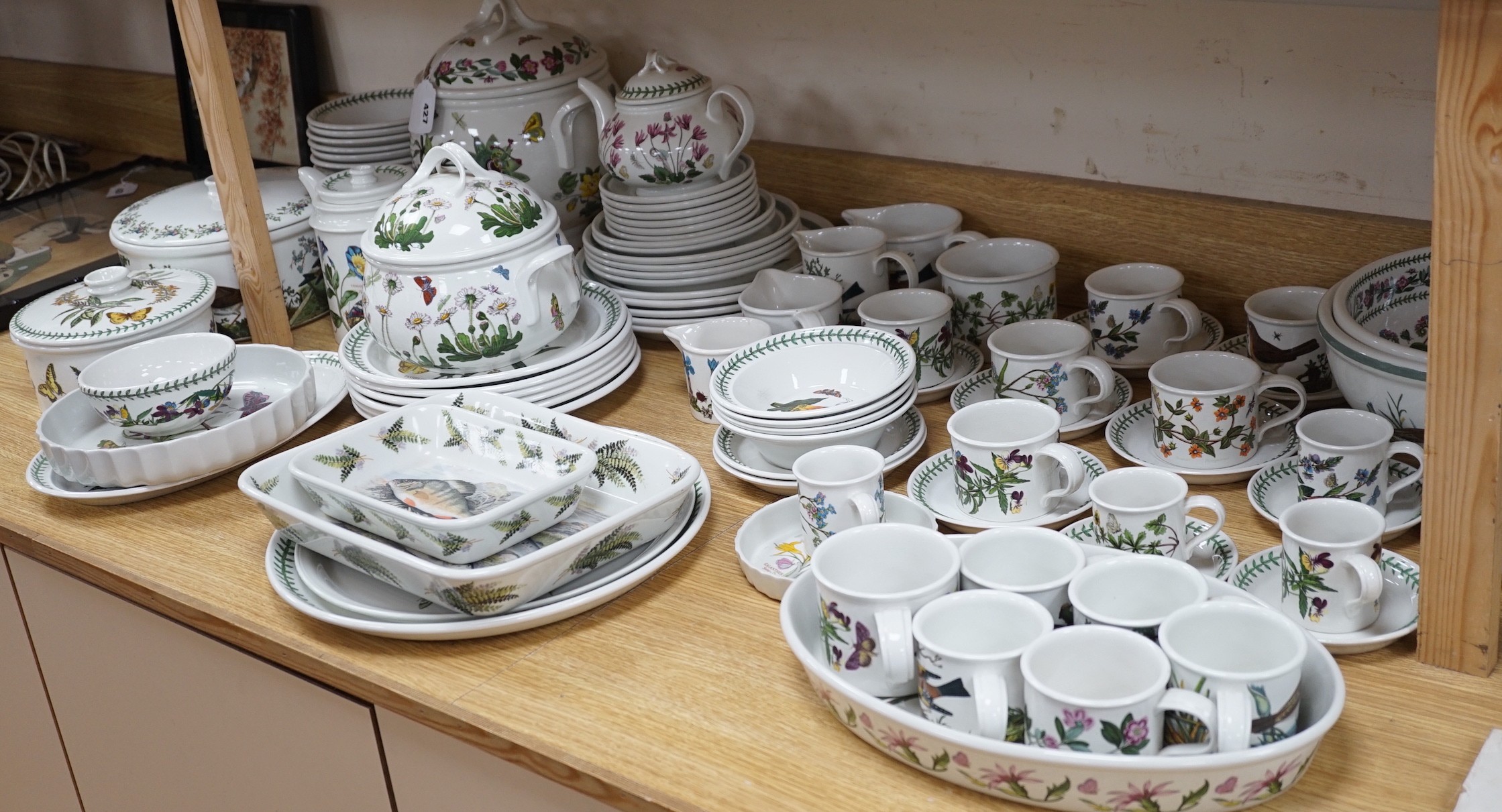A mixed Portmerion dinner service- a biscuit jar and cover, tureens, serving dishes, teapot etc